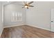 Bright bedroom showcasing wood flooring, a ceiling fan, and a window with white shutters at 3647 Allentown Dr., Conway, SC 29526