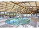 Indoor heated pool with large windows and seating at 3700 Golf Colony Dr. # 14-N, Little River, SC 29566