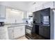 Galley kitchen with granite countertops and black appliances at 3700 Golf Colony Dr. # 14-N, Little River, SC 29566