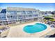 Community pool with surrounding patio and seating area at 3700 Golf Colony Dr. # 14-N, Little River, SC 29566