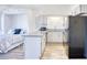 Studio apartment kitchen features granite countertops, white cabinets, and black appliances at 3700 Golf Colony Dr. # 14-N, Little River, SC 29566