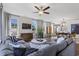 Bright living room featuring hardwood floors, a gray sectional sofa, and large windows at 4023 Bucolic Loop, Myrtle Beach, SC 29588