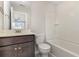 Clean bathroom with a bathtub, toilet and dark brown vanity at 4112 Alvina Way, Myrtle Beach, SC 29579