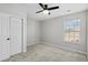 Bedroom with light-colored walls, carpet, a ceiling fan and a window at 413 Cotton Grass Dr., Loris, SC 29569