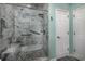 Modern bathroom with a large walk-in shower, marble tile, and built-in bench at 4200 Coquina Harbour Dr. # H3, Little River, SC 29566