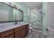 Modern bathroom with marble shower and wood vanity at 4200 Coquina Harbour Dr. # H3, Little River, SC 29566