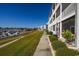 Building exterior showcasing landscaping and a walkway near the marina at 4200 Coquina Harbour Dr. # H3, Little River, SC 29566