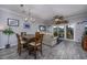 Bright dining area with wood table and chairs, adjacent to living room and access to balcony at 4200 Coquina Harbour Dr. # H3, Little River, SC 29566