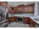 Modern kitchen with stainless steel appliances and wood cabinets at 4200 Coquina Harbour Dr. # H3, Little River, SC 29566