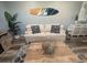 Bright living room with comfortable seating, coastal artwork, and a stylish coffee table, ideal for a serene atmosphere at 4305 N Ocean Blvd. # 205, North Myrtle Beach, SC 29582