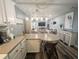 Open floorplan showcasing the kitchen and living room, creating an inviting space with coastal decor and modern lighting at 4305 N Ocean Blvd. # 205, North Myrtle Beach, SC 29582