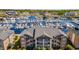 Stunning aerial view of the condo complex overlooking a beautiful marina filled with boats and surrounding buildings at 4609 Lightkeepers Way # 11J, Little River, SC 29566