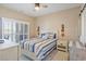 Comfortable bedroom featuring a large bed, stylish furniture, and access to a private balcony at 4609 Lightkeepers Way # 11J, Little River, SC 29566