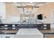 Kitchen featuring a deep farmhouse sink, black marble countertops, with an open concept living space overlooking the marina at 4609 Lightkeepers Way # 11J, Little River, SC 29566