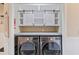 Organized laundry room featuring sliding barn doors above a modern washer and dryer set for efficient space-saving at 4609 Lightkeepers Way # 11J, Little River, SC 29566