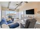 Bright living room featuring vaulted ceilings, exposed beams, comfortable seating and marina views at 4609 Lightkeepers Way # 11J, Little River, SC 29566