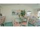 Bright dining area with glass table and floral patterned chairs at 4625 Lightkeepers Way # L, Little River, SC 29566
