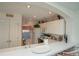 Kitchen boasts white cabinets, an electric range, and a breakfast bar at 4625 Lightkeepers Way # L, Little River, SC 29566