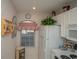 White kitchen with refrigerator, stove, and window at 4625 Lightkeepers Way # L, Little River, SC 29566