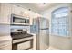 Stainless steel appliances and white cabinetry in this kitchen at 4629 Lightkeepers Way # 6-I, Little River, SC 29566