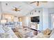 Living room with hardwood floors, vaulted ceilings, and kitchen view at 4629 Lightkeepers Way # 6-I, Little River, SC 29566