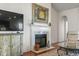 Living room features a white marble fireplace and a large TV at 5719 Coquina Po Coquina Point Dr., North Myrtle Beach, SC 29582