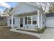 Charming light blue exterior with a covered porch and detached garage at 508 Truitt Dr., Longs, SC 29568