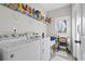 Bright laundry room with washer, dryer, and shelving at 508 Truitt Dr., Longs, SC 29568