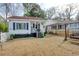 White cottage with red roof, porch, and yard; next to a similar home at 514 Palm St., Georgetown, SC 29440