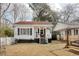 White cottage with red roof, porch, and yard; next to a similar home at 514 Palm St., Georgetown, SC 29440