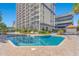 Community pool with surrounding lounge chairs and building view at 5308 N Ocean Blvd. # 1406, Myrtle Beach, SC 29577
