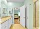 Bright bathroom with double vanity and granite counters, open doorway view to bedroom at 5314 Abbey Park Loop, Myrtle Beach, SC 29579