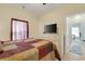 Bedroom with a patchwork quilt, wood floors, and large window with sheer curtains at 5314 Abbey Park Loop, Myrtle Beach, SC 29579