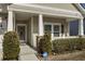Inviting front porch with stone accents, white railings, and well-maintained landscaping at 5314 Abbey Park Loop, Myrtle Beach, SC 29579