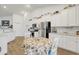 Bright kitchen with white cabinets, stainless steel appliances, and a cozy breakfast nook at 5314 Abbey Park Loop, Myrtle Beach, SC 29579