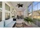 Covered and screened patio with a ceiling fan, a sofa, table, and view of the backyard at 5314 Abbey Park Loop, Myrtle Beach, SC 29579