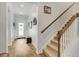 Beige carpeted staircase with a wooden handrail at 5314 Abbey Park Loop, Myrtle Beach, SC 29579