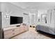 Bedroom with TV, dresser, and ensuite bathroom access at 5523 North Ocean Blvd. # 1402, Myrtle Beach, SC 29577