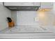 Modern electric cooktop with overhead vent hood at 5523 North Ocean Blvd. # 1402, Myrtle Beach, SC 29577