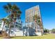 Ocean Forest Plaza building, featuring palm trees and signage at 5523 North Ocean Blvd. # 1402, Myrtle Beach, SC 29577