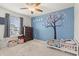 Bright bedroom with tree wall decal, dresser, and toddler bed at 556 Majorca Loop, Myrtle Beach, SC 29579