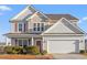 Two-story house with gray siding, a double garage, and landscaping at 556 Majorca Loop, Myrtle Beach, SC 29579