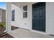 Dark blue front door, white siding, and small porch at 56 Cape Point Dr., Conway, SC 29527