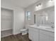 Stylish bathroom with double sinks, ample vanity storage, and modern fixtures with a window and walk-in closet at 57 Cape Point Dr., Conway, SC 29527