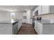 Modern kitchen features stainless steel appliances, white cabinetry, granite countertops, and wood-look flooring at 57 Cape Point Dr., Conway, SC 29527