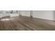 The bright living room features wood-look floors, white walls, and kitchen island in the background at 57 Cape Point Dr., Conway, SC 29527