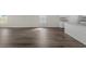 Light-filled living room has modern wood-look flooring, white walls, and views of the kitchen at 57 Cape Point Dr., Conway, SC 29527