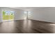 Open living room boasts natural light, wood-look flooring, and sliding glass doors to a patio at 57 Cape Point Dr., Conway, SC 29527