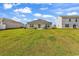 Spacious backyard with green grass, patio set, and sliding glass doors to the house at 589 Talisman Trail, Longs, SC 29568