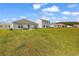 Open backyard area with green grass and patio furniture, ideal for outdoor gatherings at 589 Talisman Trail, Longs, SC 29568